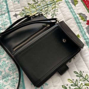 Black crossbody. Plenty of card slots, phone case, long strap, zipper pocket